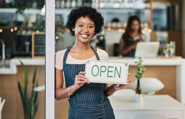 Happy woman, open sign and portrait at cafe of waitress or small business owner for morning or ready to serve. African female person at restaurant holding board for coffee shop or cafeteria opening