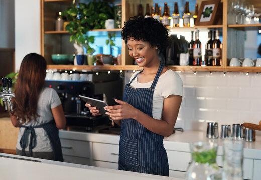 Happy woman, tablet and waitress in management at cafe for order, inventory or checking stock at restaurant. African female person, barista or manager on technology for small business at coffee shop