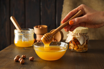 Concept of tasty and sweet food - honey with nuts