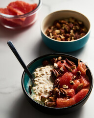 Overnight oats with milk and greek yogurt. healthy breakfast with nuts with grapefruit, honey and cinnamon