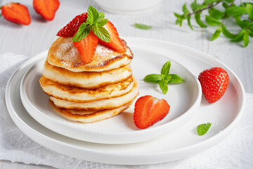 Yummy and fresh mini pancakes with strawberry for summer breakfast