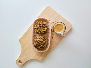 Coffee and muffins with crumble topping on wooden board