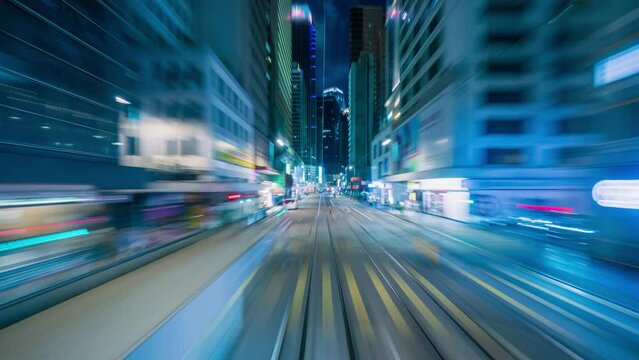 4K Hyperlapse motion blur of tram moving fast speed through street of Hong Kong downtown at night, China
