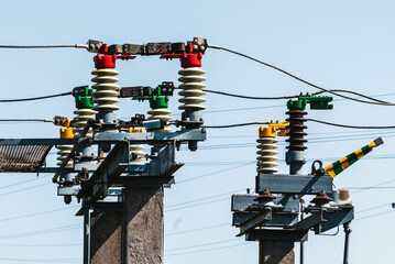 High voltage transformer against the blue sky. Electric current redistribution substation.Summer...