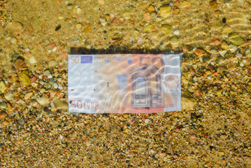 European financial crisis economics concept.Euro banknote sinking in water as a symbol of global economic crisis in Europe.Money and business concept.