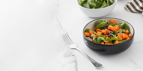  Green salad with sweet potatoes and sesame seeds. Vegan dish. Healthy eating. Copy space