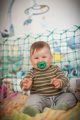 Portrait of cute happy baby boy looking at camera. Joy and happiness concept. Love and family emotion