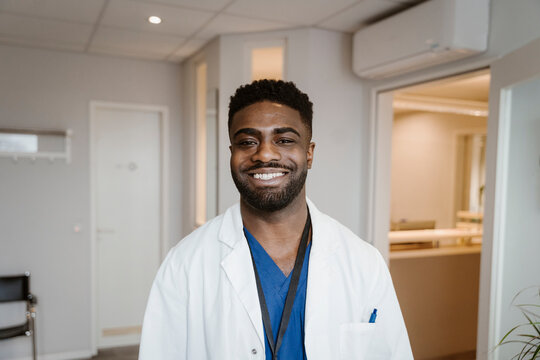 Portrait of smiling young male doctor wearing lab coat at hospital