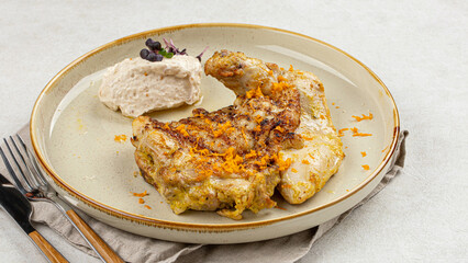 Portion of gourmet cooked chicken with nut cream