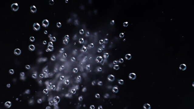 Top view closeup scene on chaotic moving pattern of bubble isolated on black background, fizz texture of soda water drink when gas release, massive of small balloon flowing in the air