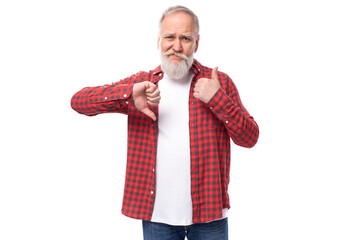 handsome frustrated 60s elderly man with a gray beard in a shirt