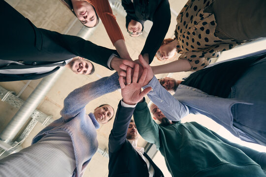 A group of businessmen holding hands together to symbolize unity and strength