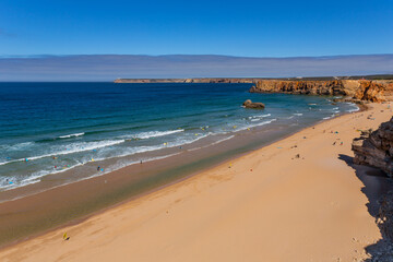 View of surfers on sandy beach