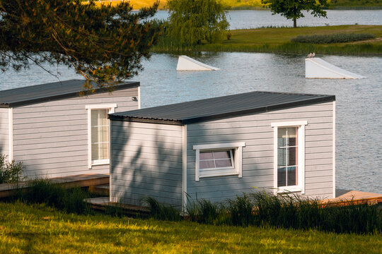 Overwater wooden bungalows on the lake with a wake park equipment
