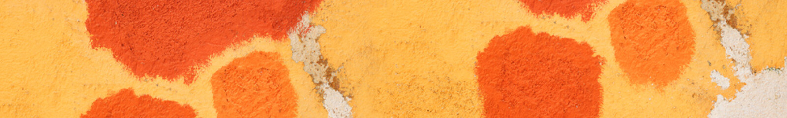 Texture of old house concrete wall painted into deep Vibrant warm golden yellow color with orange spots and cracks on the surface. Decorative plaster. Abstract design grunge background. Copy space
