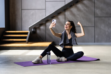 Young attractive woman break pause sit mat make selfie cellphone sportswear home