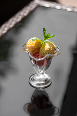 Portion of fresh ice cream balls in a dessert bowl