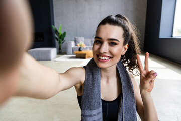 Young woman doing self portrait on yoga mat. Home vacation indoors portrait. Lifestyle action....