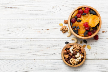 healthy snack: mixed nuts and dried fruits in bowl on table background, almond, pineapple, cranberry, cherry, apricot, cashew