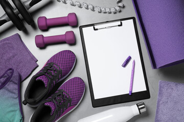 Clipboard with paper sheet, pen and sports equipment on light gray background, flat lay. Personal training
