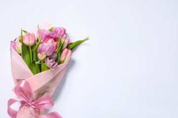 Beautiful bouquet of colorful tulip flowers on white background, top view. Space for text