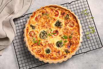 Delicious homemade quiche on light gray table, top view
