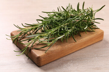 Sprigs of fresh rosemary on white wooden table, closeup