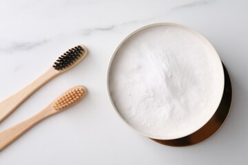 Fototapeta na wymiar Bamboo toothbrushes and bowl of baking soda on white marble table, flat lay