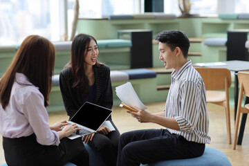 Collaborative process of young asian business people team working together discussing, researching,...