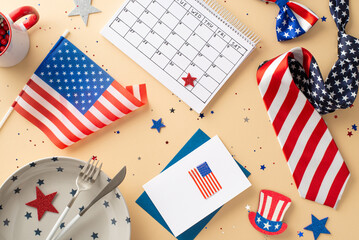 Fourth of July celebration objects. Top view of table setting, plate, cutlery, mug, envelope with postcard, stars, confetti, party necktie, bow-tie, flagpole, calendar on pastel beige background