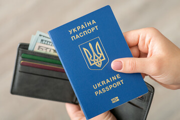 Fototapeta Passport of Ukrainian person near wallet with dollar bills. Immigration concept, travel to USA obraz