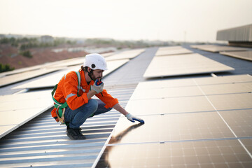 professional technician or engineer installing solar panels, Alternative energy for installed solar panels in use on roof of home
