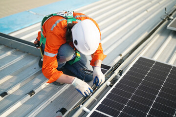 professional technician or engineer installing solar panels, Alternative energy for installed solar panels in use on roof of home