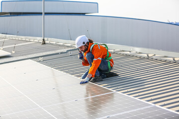 professional technician or engineer installing solar panels, Alternative energy for installed solar panels in use on roof of home
