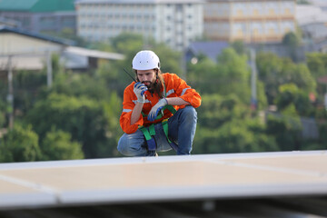 professional technician or engineer installing solar panels, Alternative energy for installed solar panels in use on roof of home