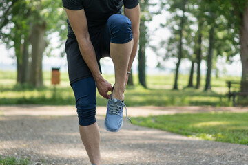 Young man puts on sneakers and gets ready for training.