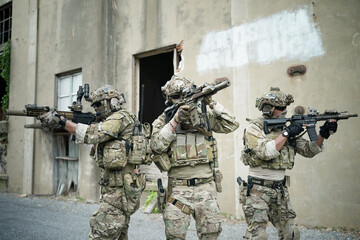 Military Soldiers Storming the Enemy Building - obrazy, fototapety, plakaty