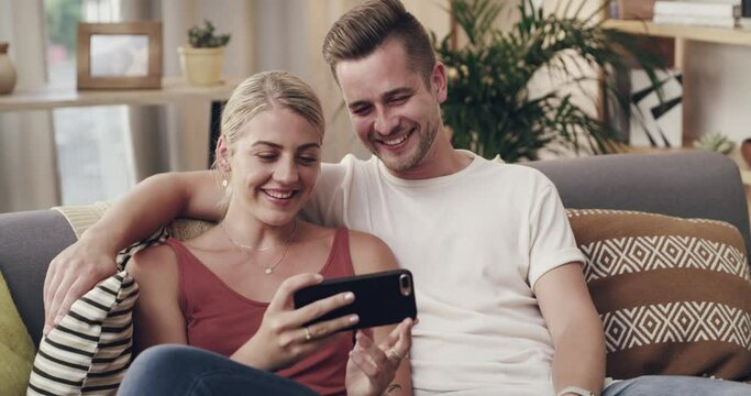 Couple, couch and phone for funny video with laughing, relax and bonding on meme, web and social network app. Man, woman and sofa in home living room with smartphone, movie or streaming subscription