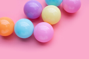 Colorful balls on pink background.