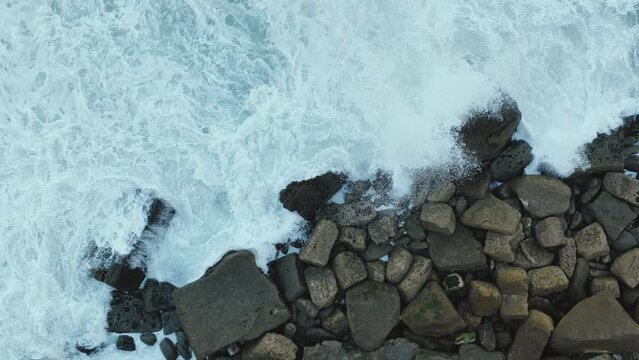 White waves of the Atlantic Ocean crashing against a rocky shore 4k