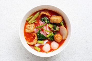 A bowl of pink flat noodles