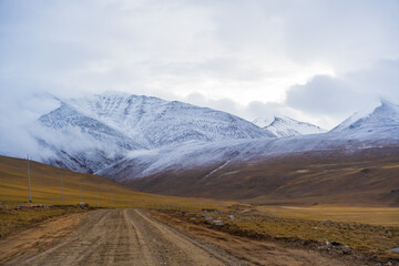 snow covered mountains, cloudy sky at the way from Moriri lake to Leh city, Ladakh, India