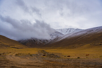 Fototapeta na wymiar clouds covered mountains, cloudy sky, landscape at Spangnak Ri near Moriri lake, Ladakh, India