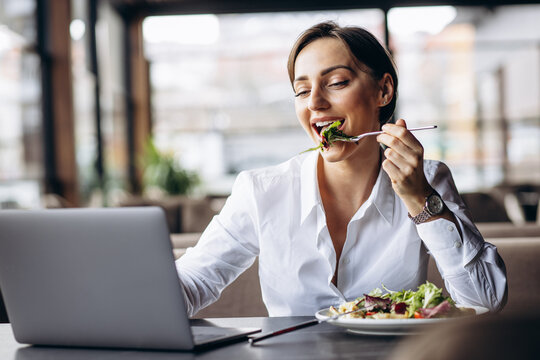 Business Woman Working On Laptop And Eating Salad