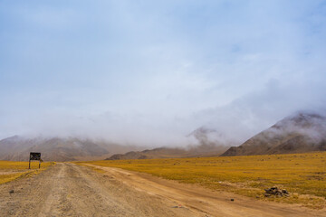 withered grass field, the mountain and cloud sky at Tso Kar lake, Beautiful scenery along the way at Ladakh, India. The Tso Kar or Tsho kar is a fluctuating salt lake