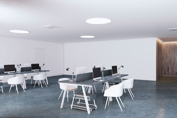 Perspective view of open space office coworking interior with comfortable workplaces, desks with computers, concrete floor and white walls,. Modern workspace design. 3D Rendering