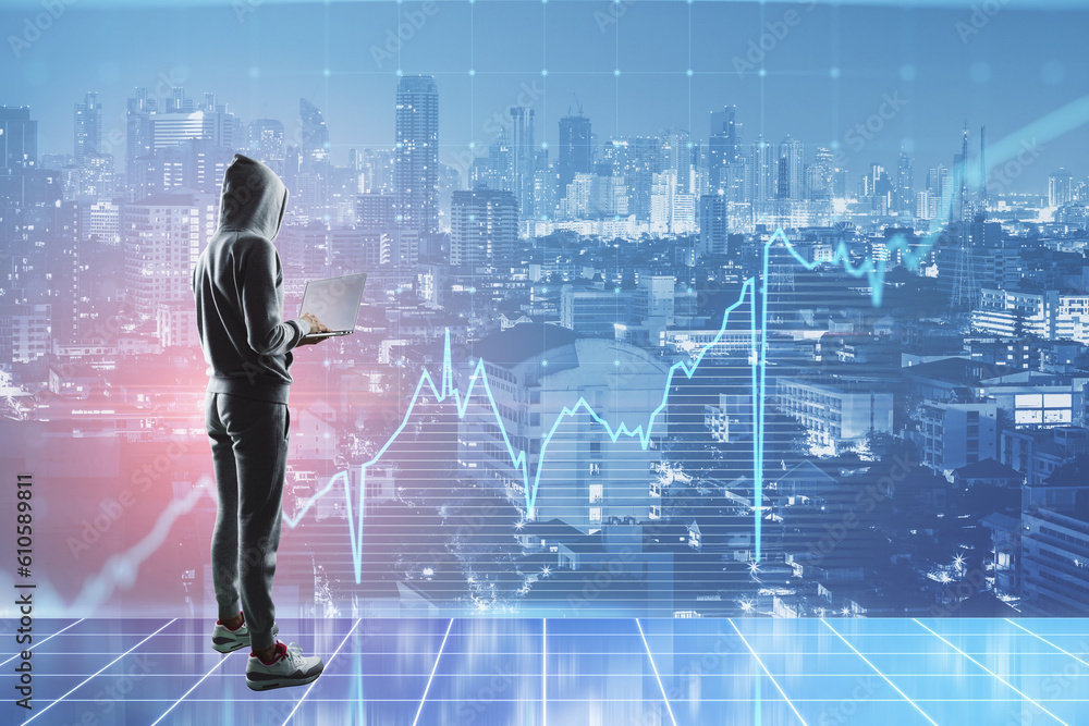 Poster hacker with laptop standing on abstract toned city background with business grid chart. finance and 