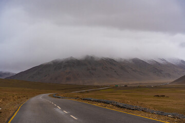  the road, mountain and cloud sky at Tanglang La pass in Ladakh, India, is the second highest...