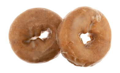 Top view of two whole freshly baked cake donuts isolated on a white background.