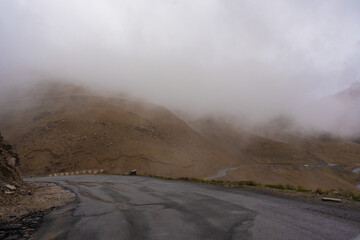 The road, Snow covered mountains, cloudy sky at Taglang La Pass, Keylong-Leh Road, the way from Moriri lake to Manali town, Ladakh, India